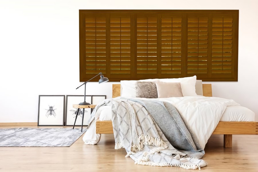 Wood plantation shutters in bedroom